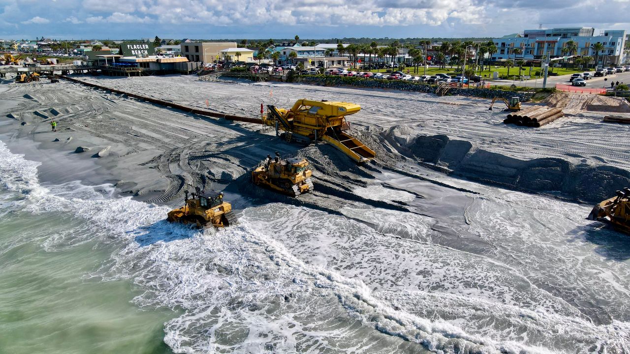 Aerial view of beach restoration with machinery at Flagler Beach, Florida.